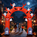 Red dead-tree Halloween arch inflatable with small ghosts and tombstones over a front path, kids walking through