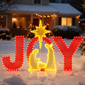 Red lighted JOY yard sign with a gold nativity silhouette and star in place of the O on snow