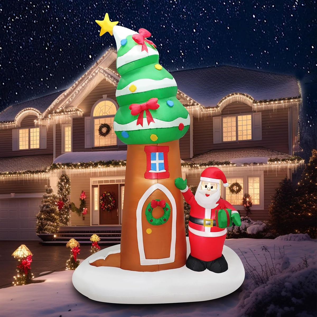 Inflatable tree house with a round door and wreath topped by a Christmas tree, Santa standing in front