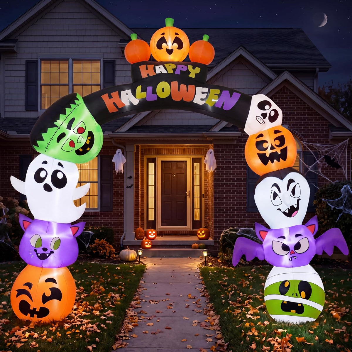 Cute Happy Halloween arch inflatable with stacked pumpkins, ghosts, a bat and a mummy over a front path